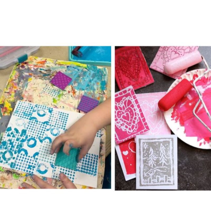A child's hands press a textured stamp onto a paper covered in blue patterns, while in the background, colorful, stamped cards and a paint roller rest on a plate.