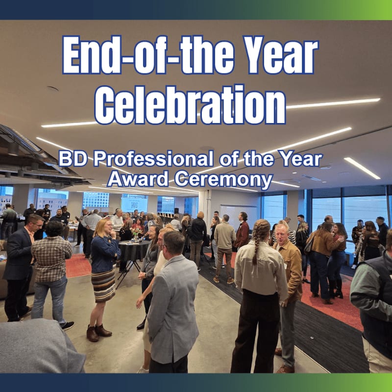 People mingle in a brightly lit room with modern ceiling lights during an "End-of-the-Year Celebration BD-Professional of the Year Award Ceremony."