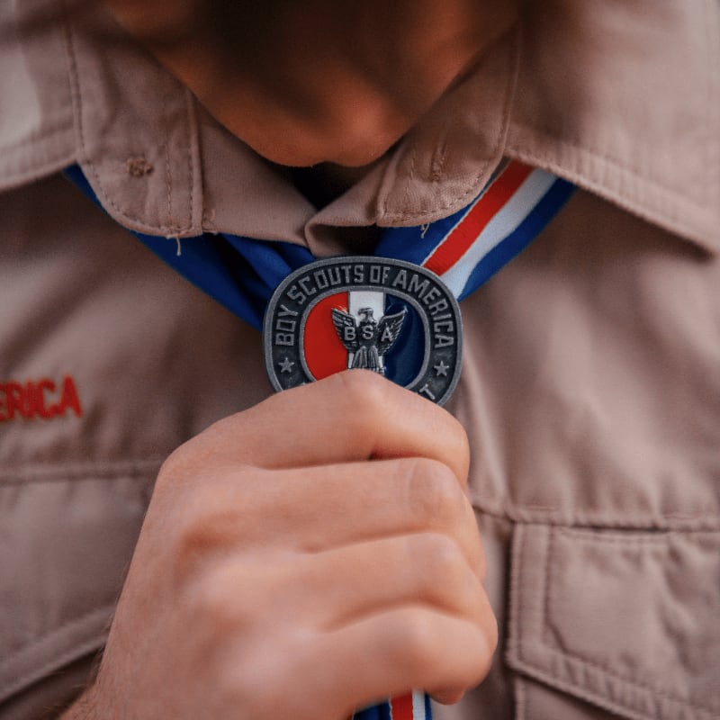 a close up of a person tying a tie