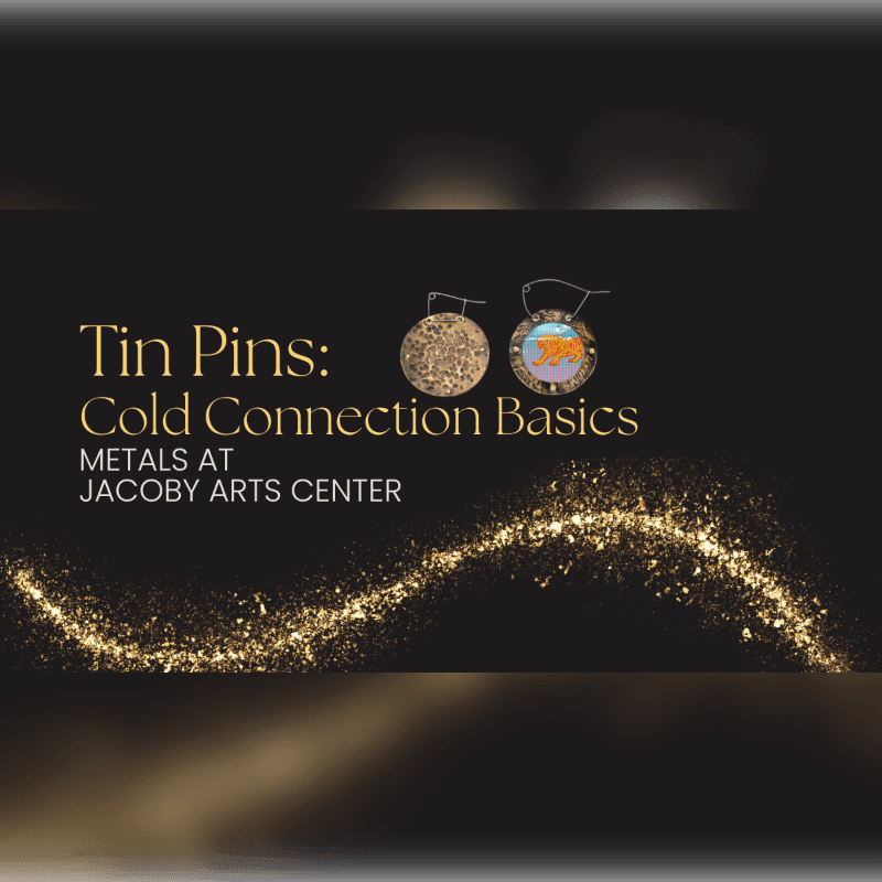 Two decorative tin pins hang against a dark background with a sparkling golden wave in the foreground.