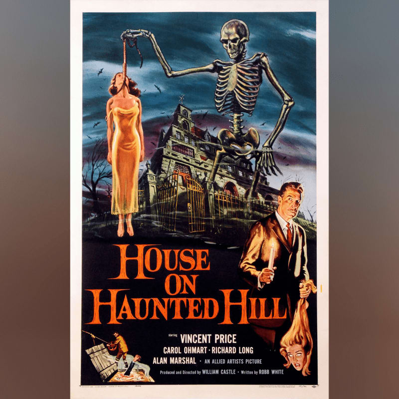 A skeletal figure dangles a woman by her hair in front of a spooky mansion, while a man holding a candle stands in the foreground.