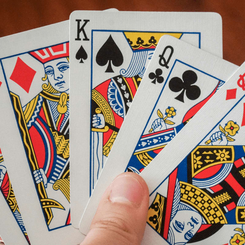 a hand holding a game card