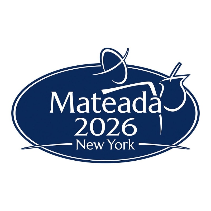 A dark blue oval logo with white text "Mateada 2026 New York" and abstract white graphics of a fork and a dreidel is set against a white background.