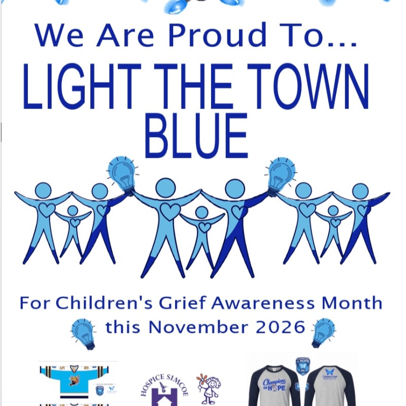 A group of blue stick figures holding lightbulbs above their heads form the foreground, while the background features text announcing "We Are Proud To... LIGHT THE TOWN BLUE" for Children's Grief Awareness Month in November 2026.