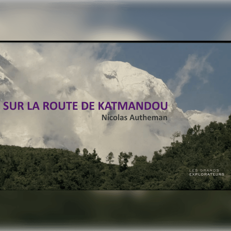 Lush green hills in the foreground lead to a majestic, snow-capped mountain range shrouded in clouds in the background, with text overlaying the scene.
