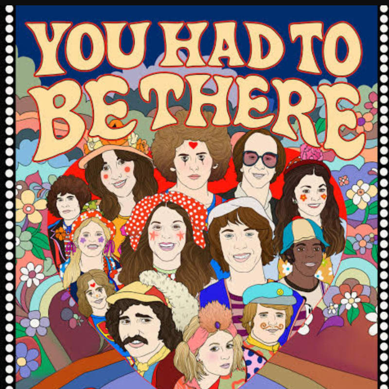 A group of people with colorful, retro hairstyles and clothing are smiling in the foreground, set against a psychedelic background of flowers and rainbows with the words "YOU HAD TO BE THERE" in large, bubbly letters.
