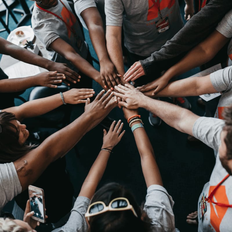 people with hands gathered in the middle