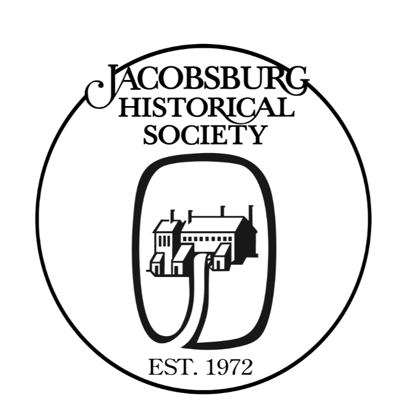 A black and white circular logo for the "Jacobsburg Historical Society" features a silhouette of a building within a large "O" in the foreground, with the establishment date "EST. 1972" at the bottom against a white background.