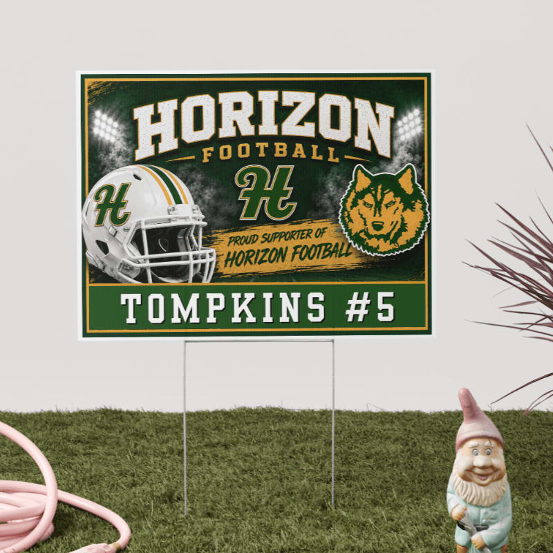 A yard sign for "Horizon Football" with a helmet and husky mascot is planted in green grass, with a garden gnome and pink hose in the foreground and a plant in the background.