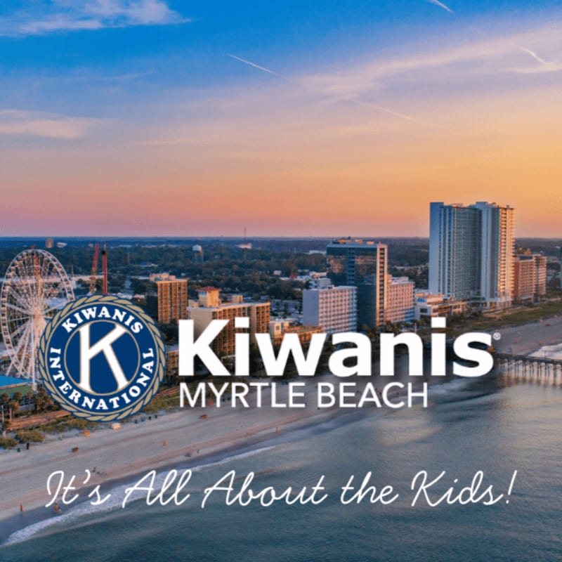 A beach with a Ferris wheel and buildings in the background is overlaid with the Kiwanis Myrtle Beach logo and the slogan "It's All About the Kids!".