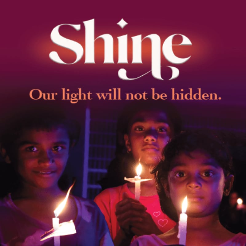 Three children hold lit candles in the foreground, with the word "Shine" and a tagline in the background.