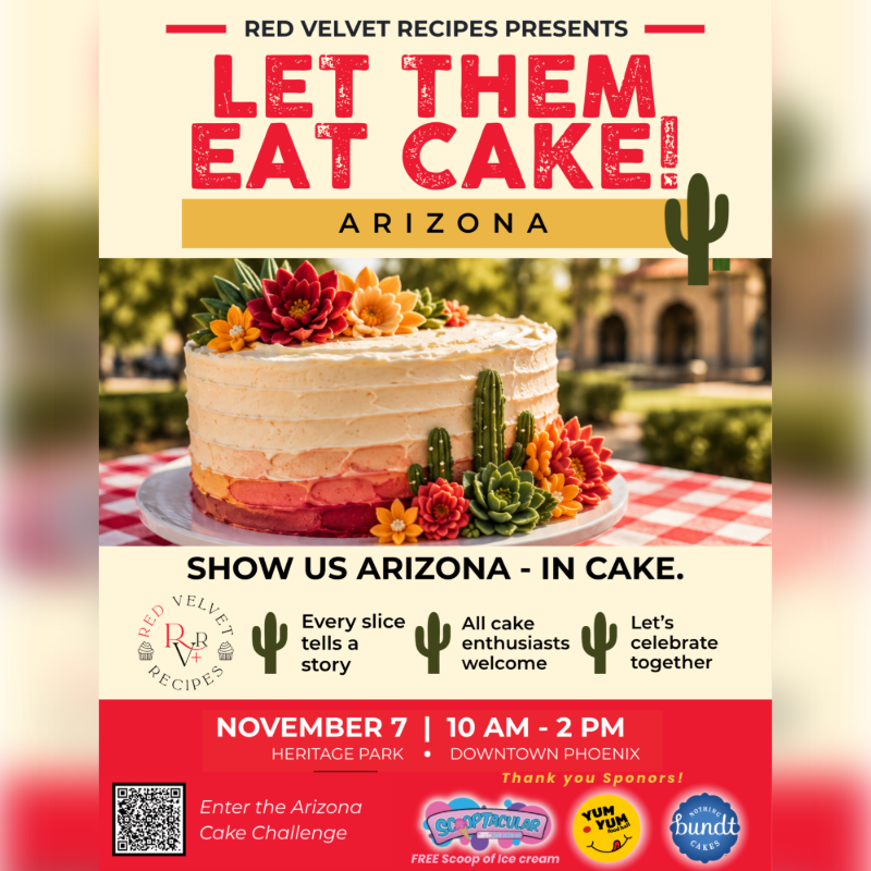 A beautifully decorated cake with desert-themed frosting sits on a table with a red and white checkered tablecloth, while a blurred background shows buildings and trees.