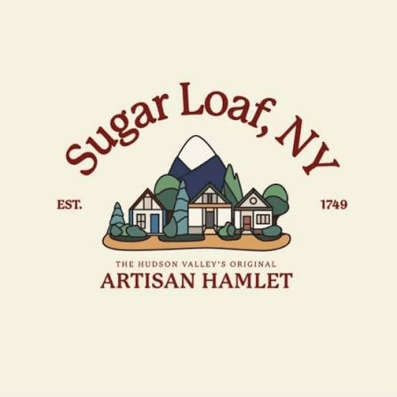 A stylized logo features a row of quaint houses and trees in the foreground, with a mountain peak in the background, all under the text "Sugar Loaf, NY".