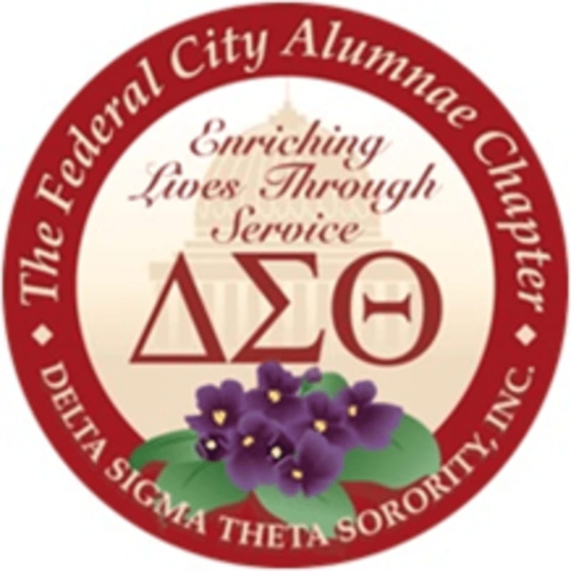 A circular emblem features purple violets in the foreground against a background of Greek letters and the U.S. Capitol building, all enclosed within a red border inscribed with "The Federal City Alumnae Chapter Delta Sigma Theta Sorority, Inc."