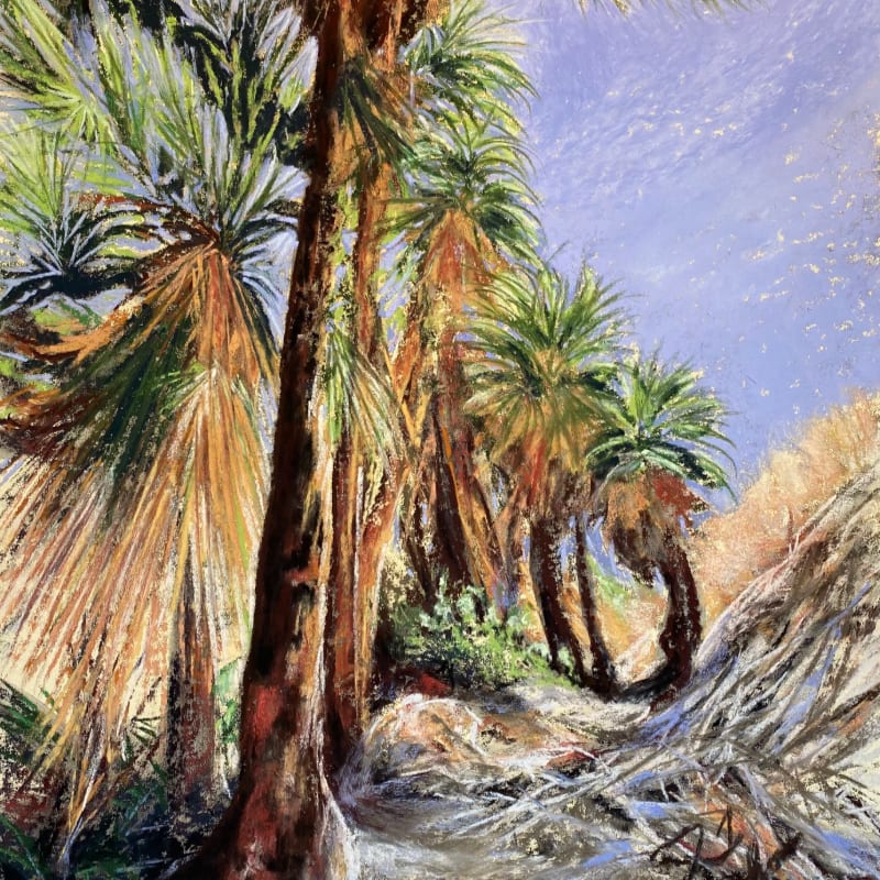 A cluster of palm trees with dry, fibrous trunks and green fronds dominates the foreground, while a dusty, sun-baked hillside and a pale blue sky with wispy clouds form the background.