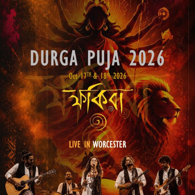 A band performs on stage in the foreground, with a vibrant Durga Puja 2026 poster featuring Goddess Durga and a lion in the background.