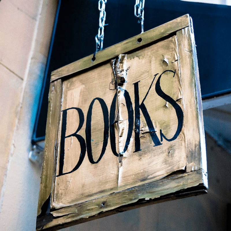 book signage hanging beside white wall