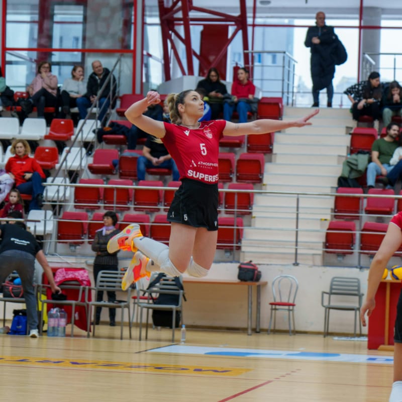 a woman jumping in the air to catch a ball