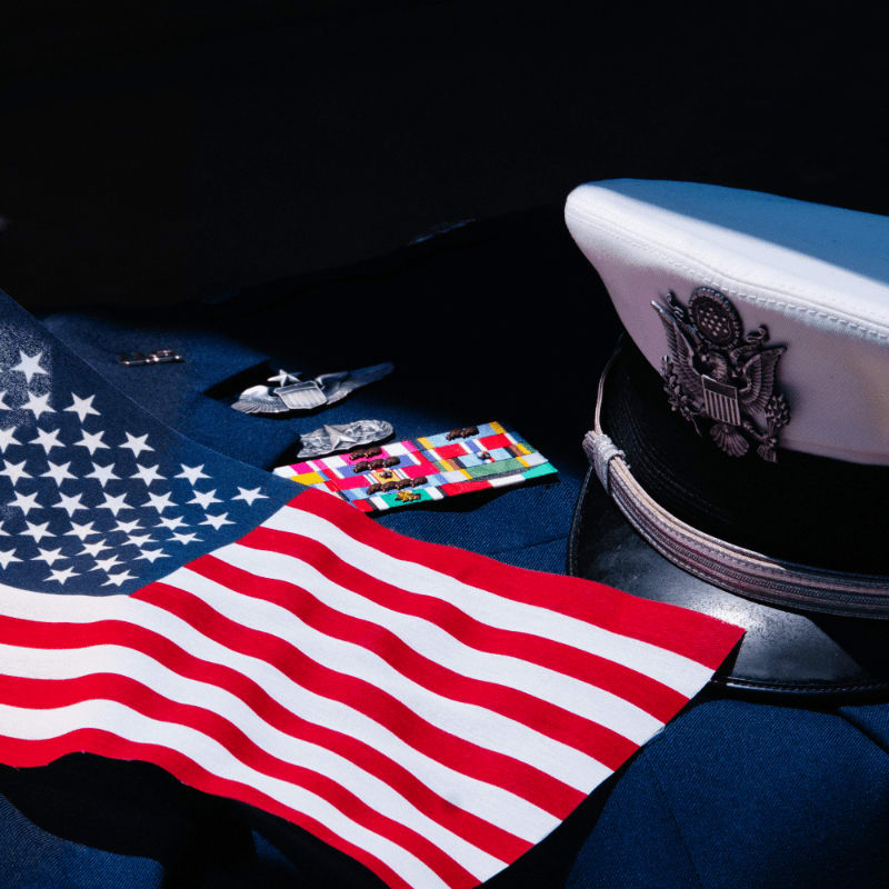 an american flag laying on top of a uniform