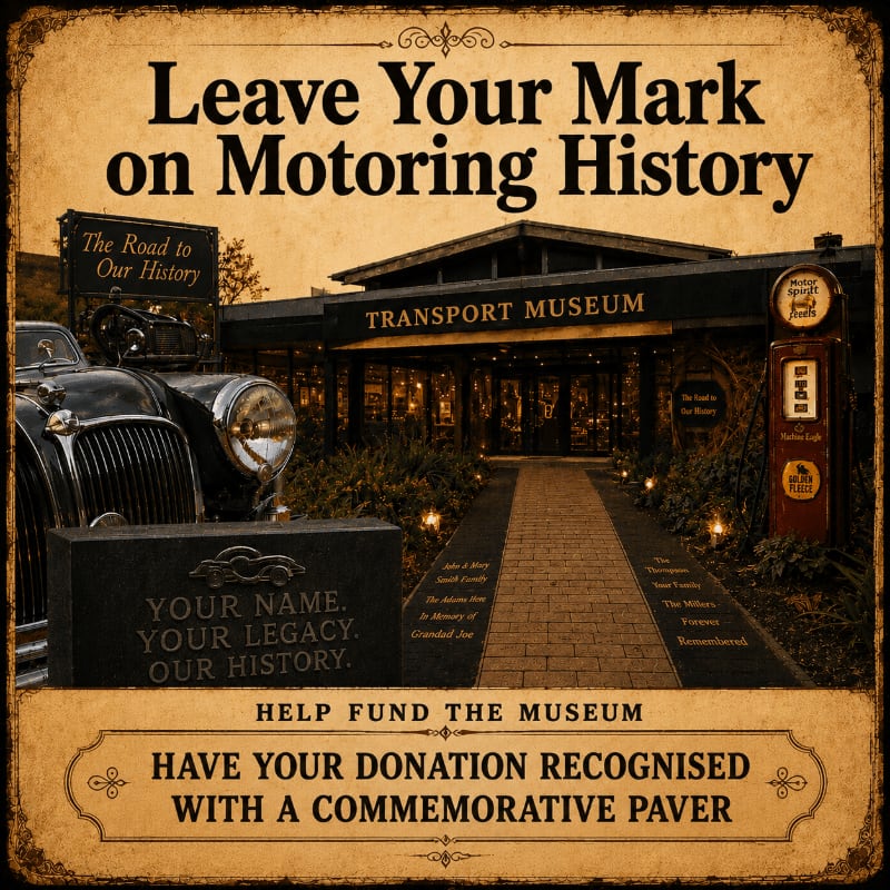 A vintage car and a commemorative paver sit in the foreground, leading to the entrance of a transport museum in the background.