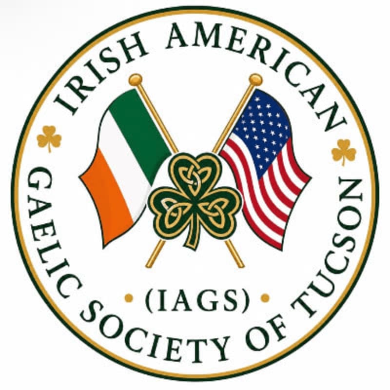 In the foreground, the Irish and American flags are crossed behind a shamrock, all within a circular emblem that reads "IRISH AMERICAN GAELIC SOCIETY OF TUCSON (IAGS)" in the background.