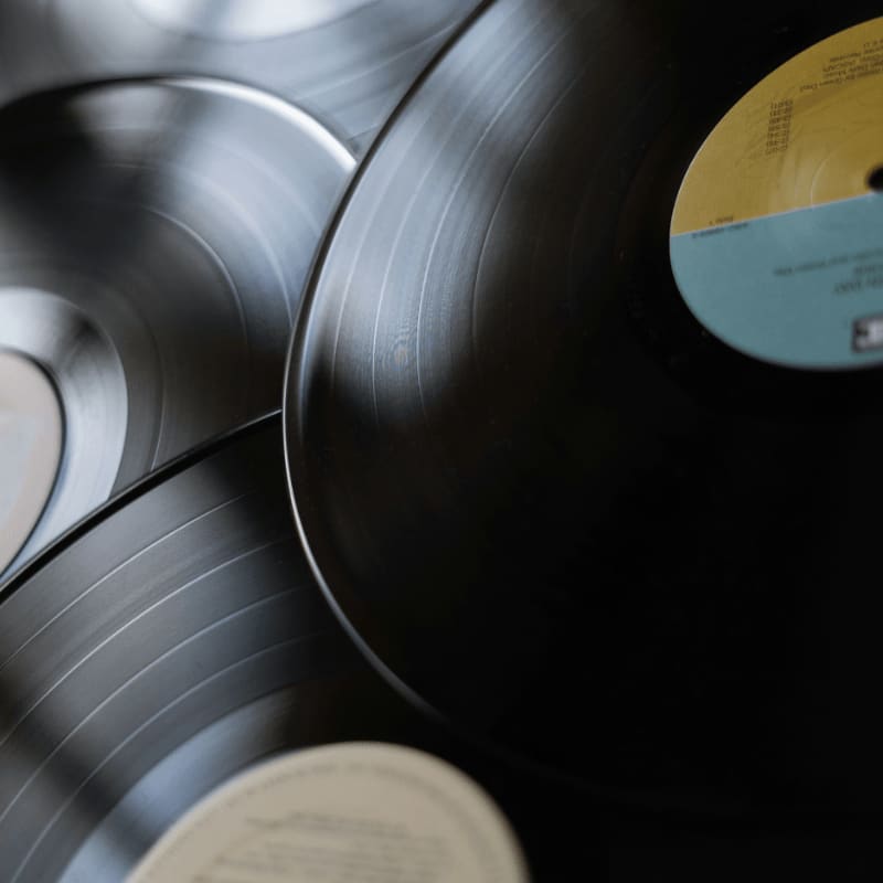 black vinyl record on silver round plate