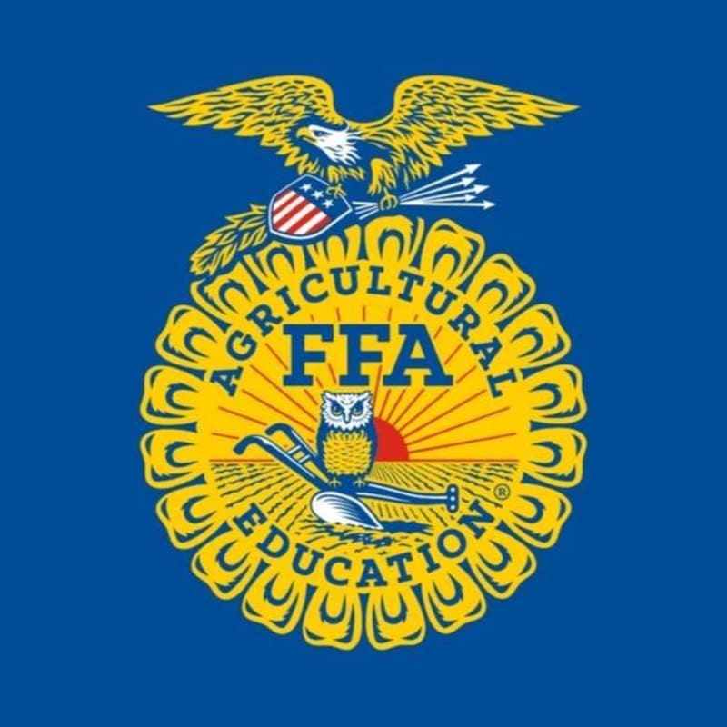 A golden FFA emblem with an owl, rising sun, and agricultural tools is centered on a vibrant blue background.