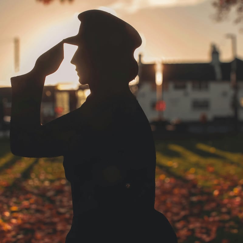 A silhouette of a woman standing in a field