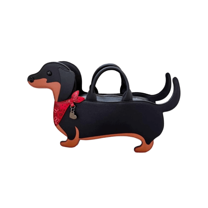 A black dachshund-shaped handbag with a red bandana is presented against a plain white background.