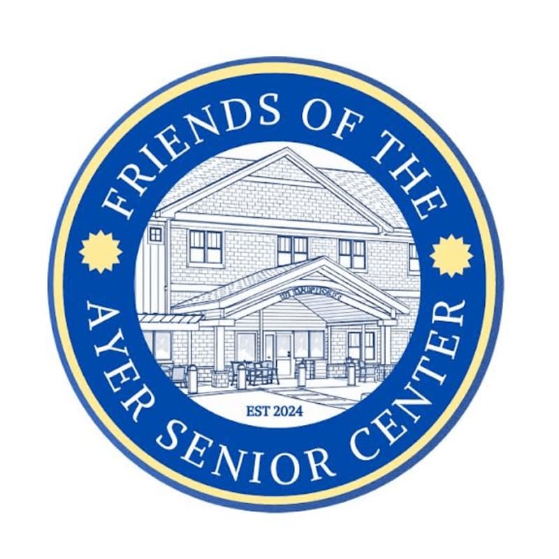A circular emblem with "FRIENDS OF THE AYER SENIOR CENTER EST 2024" in blue lettering on a white background frames a sketch of a building with a covered entrance in the foreground and a light-colored roof and siding in the background.