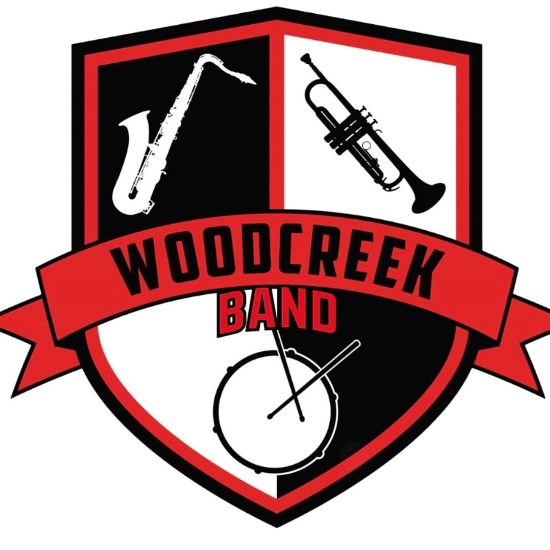 A shield with a saxophone, trumpet, and drum is emblazoned with "WOODCREEK BAND" across a red banner.