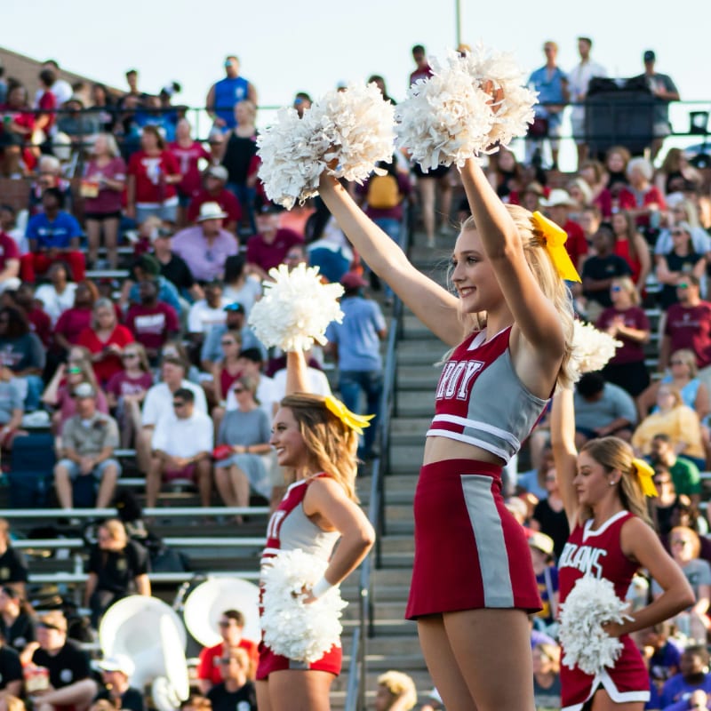 women in white and red uniform dancing on stage during daytime
