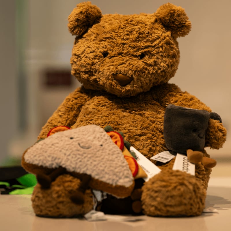 A brown teddy bear sitting on top of a table