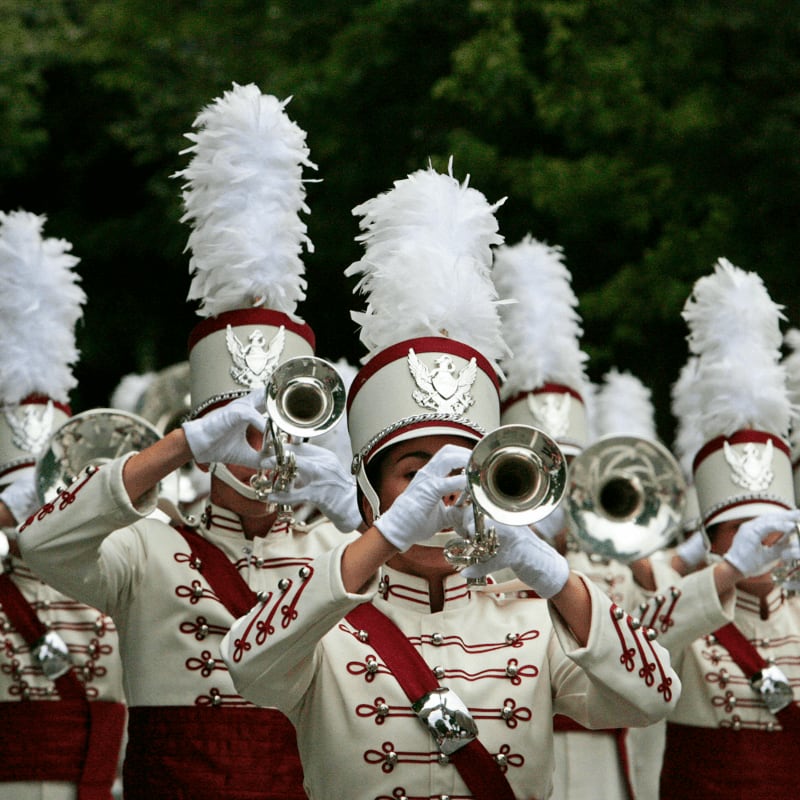 a marching band with white and red uniforms