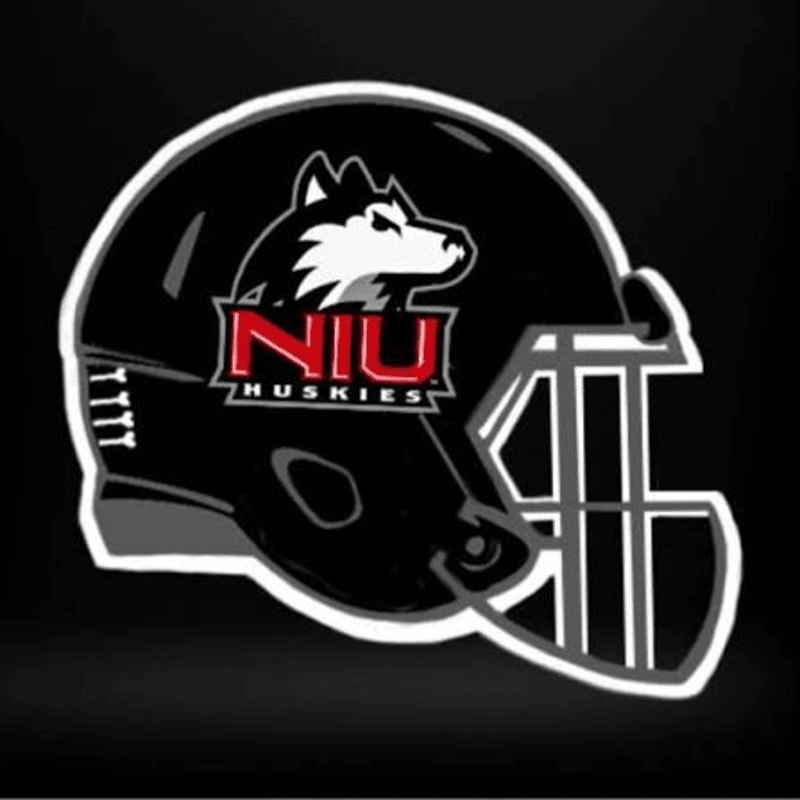 A black football helmet with the NIU Huskies logo is centered against a dark, blurred background.