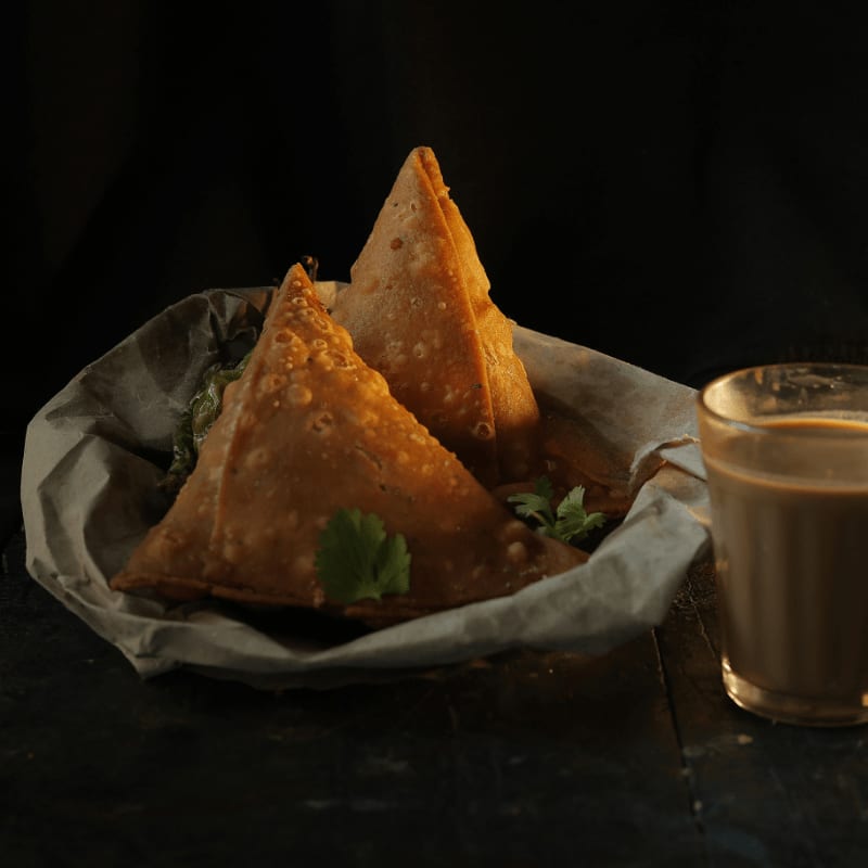 A plate of food next to a cup of coffee