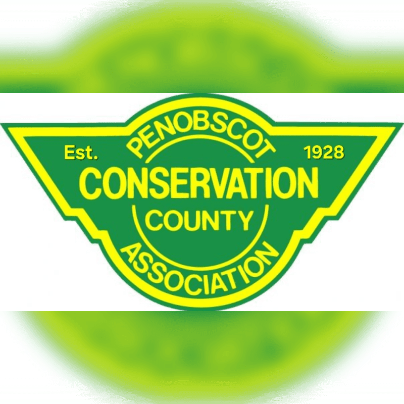 A green and yellow triangular logo for the Penobscot County Conservation Association, established in 1928, is centered against a blurred green background.