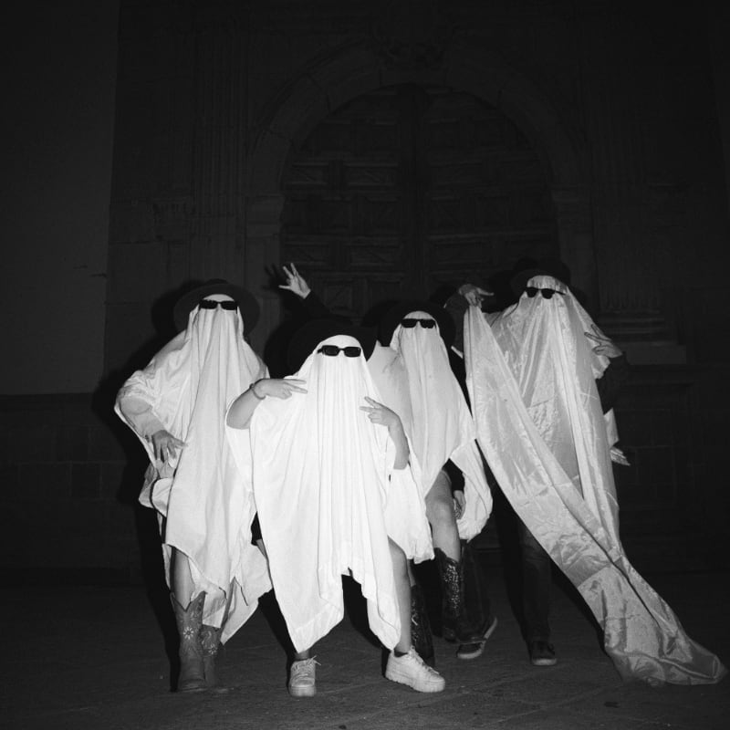A group of people dressed in ghost costumes
