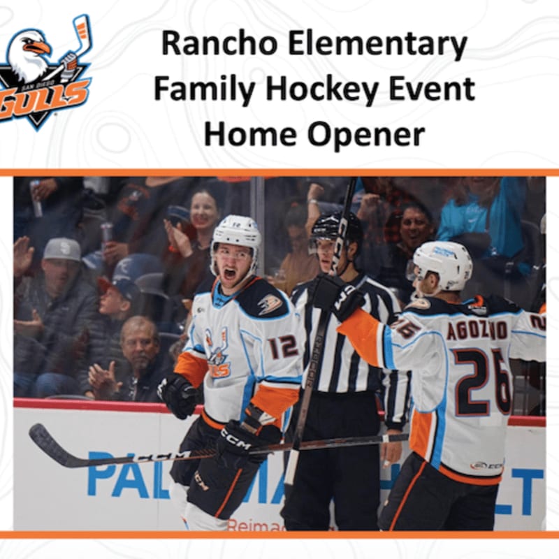 Three hockey players in orange and white uniforms celebrate on the ice in the foreground, while a blurred crowd watches from the stands in the background.