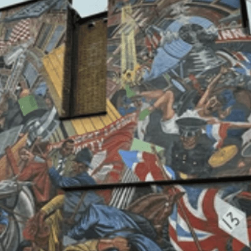 A vibrant mural fills the frame, depicting a chaotic scene of figures in historical attire and flags in the foreground, set against a brick building in the background.