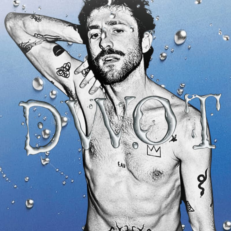 A tattooed man with wet hair poses against a blue background with water droplets and the word "DVOT" formed by water.