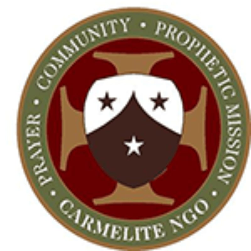 A circular emblem with the words "PRAYER COMMUNITY PROPHETIC MISSION CARMELITE NGO" encircling a shield with stars and a cross in the background.