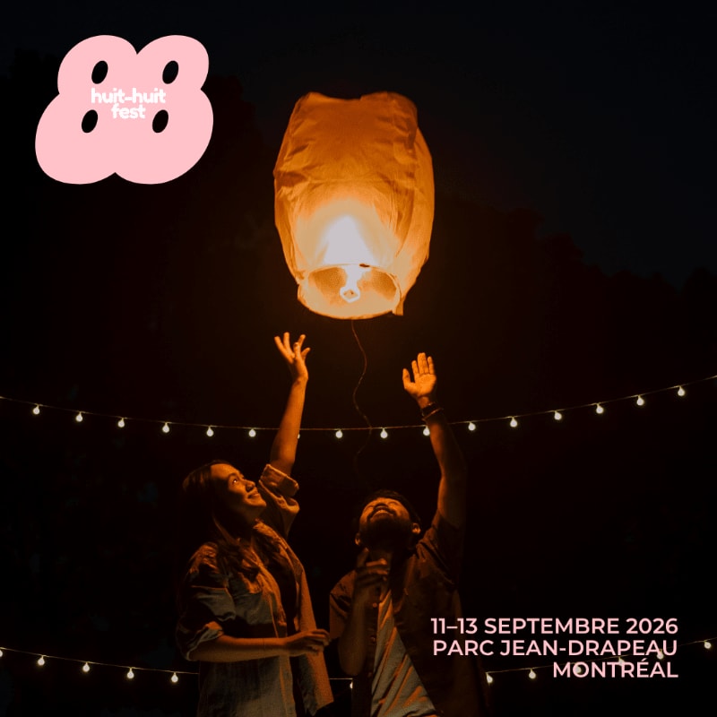 Two people reach up towards a glowing lantern in the foreground, with string lights and text indicating a festival in the background.