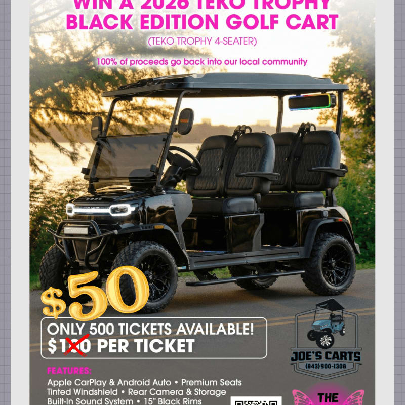 A sleek black golf cart with plush seating is prominently displayed in the foreground, set against a blurred background of trees and water.