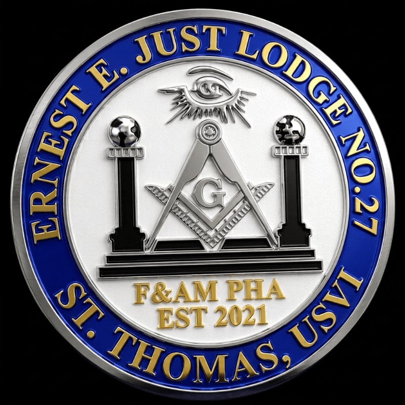 A circular emblem with the Masonic square and compass in the center is set against a dark background, with text around the perimeter reading "ERNEST E. JUST LODGE NO. 27 ST. THOMAS, USVI F&AM PHA EST 2021".