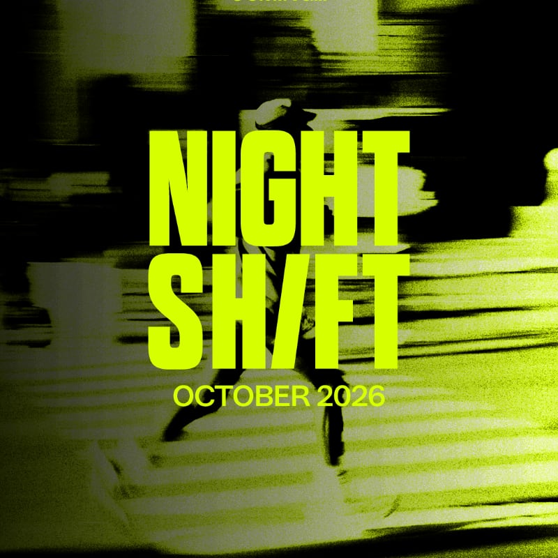 A person in silhouette crosses a street at night, with neon green text overlaying the scene.