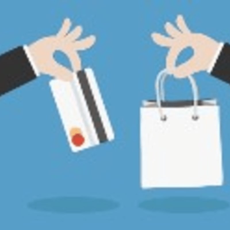 Two hands, one holding a credit card and the other a shopping bag, are presented against a solid blue background.