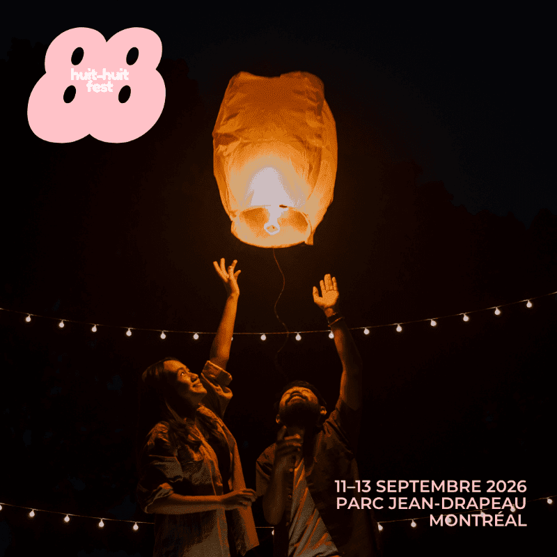 Two people reach up towards a glowing lantern against a dark sky, with string lights overhead and festival details in the lower right corner.