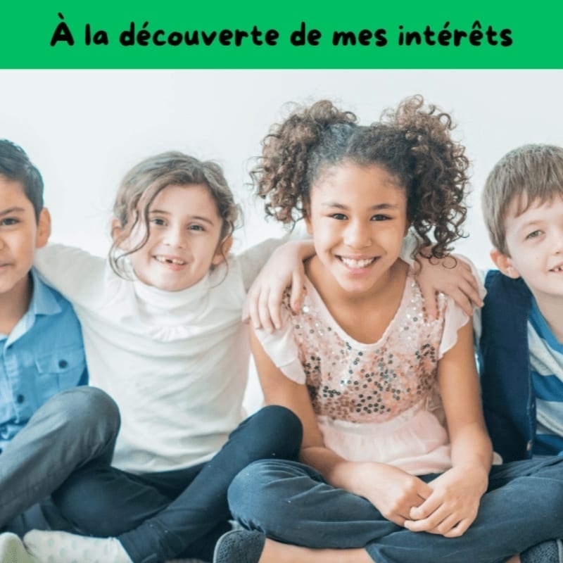 Four smiling children of diverse ethnicities sit closely together in the foreground, with a plain white background behind them.