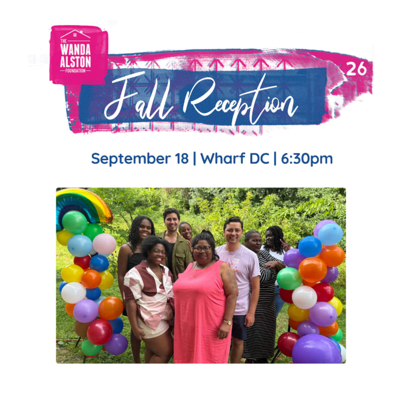 A group of people pose for a photo in front of colorful balloons, with a banner announcing "Fall Reception" above them.